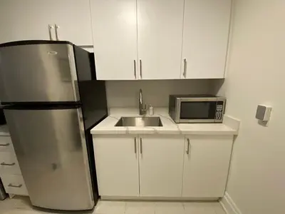 a kitchen with a refrigerator and a sink and a microwave at Yorkmills and Bayview !A Spacious and Modern Private Bdr with Shared Bathroom in Toronto