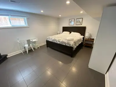 a bedroom with a bed and a table and a window at Yonge and Finch Subway !R Spacious & Stylish Prvt Bdr with Shared Bathroom in Toronto