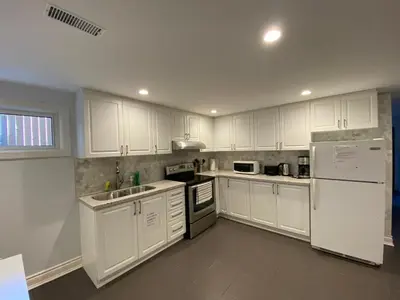 a kitchen with white cabinets and white appliances at Yonge and Finch Subway !R Spacious & Stylish Prvt Bdr with Shared Bathroom in Toronto