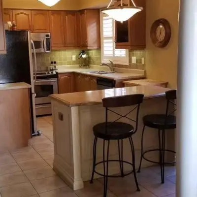 a kitchen with two bar stools at a kitchen island at Top Floor of House in S Vaughan All to Yourself in Vaughan