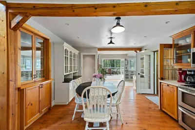 a dining room with a table and chairs in a kitchen at Marmora Retreat - Unique Waterfront Farmhouse in Marmora