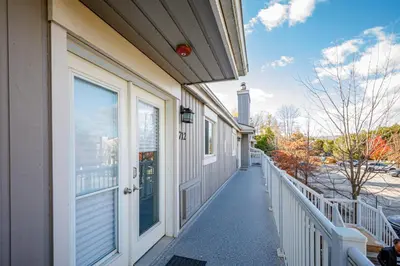 a walkway leading to a building with a door at The Alpine - Central Collingwood Condo in Collingwood