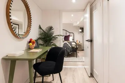 a room with a table and chairs and a mirror at Professionally Designed 1-Bedroom in Prime Toronto in Toronto