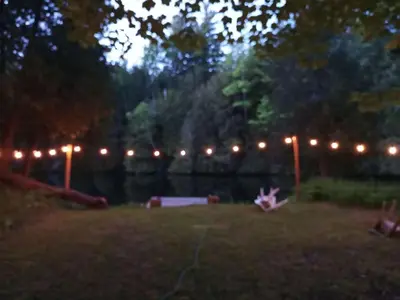 a backyard lit up at night with lights at Fireside - Waterfront Resort Style Executive Cottage in Kawartha Lakes