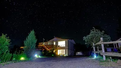 a building at night with lights in front of it at Cozy Sunset Cottage Overlooking Rice Lake in Roseneath