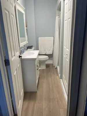 a bathroom with a sink and a toilet and a mirror at Villa in the Vines in Niagara on the Lake