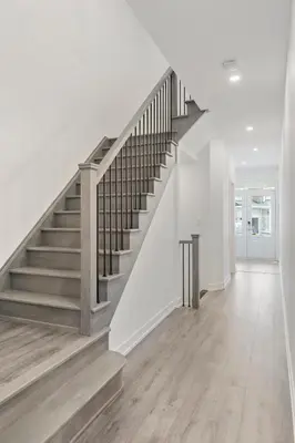 a staircase in a home with white walls and wood floors at Jewel of Blue Mountain - Walk to Ski and Village - EV plug in Blue Mountains