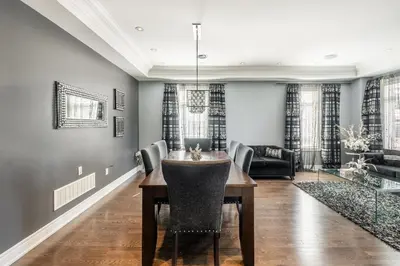 a dining room with a table and chairs at Beautiful Family Villa, Pond Facing with Huge Backyard in Brampton