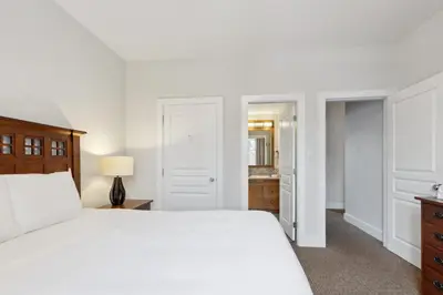 a bedroom with a white bed and a bathroom at Blue Mountain Retreat at Rivergrass in Blue Mountains