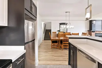 a kitchen and dining room with a dining table at Spectacular Rivergrass Chalet Steps to Blue Mtn in Blue Mountains
