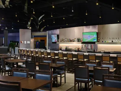an empty restaurant with tables and a bar at Great Blue Heron Hotel in Port Perry