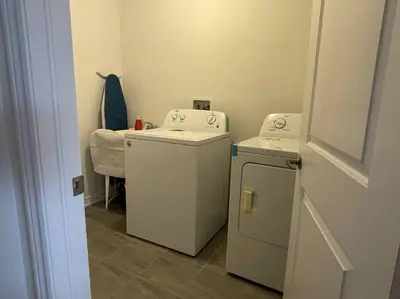 a laundry room with a washer and dryer at Rest in Quinte West - 25 mins from Batawa Ski Hill in Carrying Place