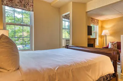 a bedroom with a large bed and two windows at The Stratford Hotel by Hoco Hotels Collection in Stratford