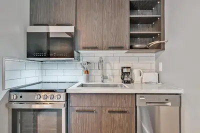 a kitchen with a sink and a stove top oven at Moira Lake Motel in Madoc