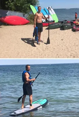 a man standing on a paddle board in the water at Stunning Stayz Luxury 2 King Suite at Friday Harbour Resort Marina Walk & Parking in Innisfil