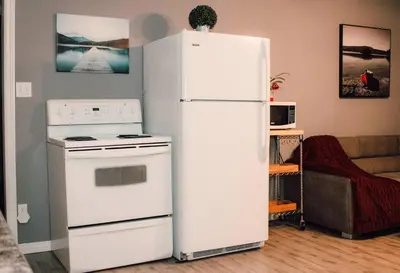 a white refrigerator and a stove in a living room at Sun Chaser Bay in Carrying Place