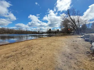a body of water with trees and clouds in the sky at Pines Bay Waterfront cottage with Hot tub! in Kawartha Lakes