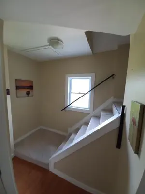 an empty room with a staircase with a window at Niagara Falls Dream Family Retreat in Niagara Falls