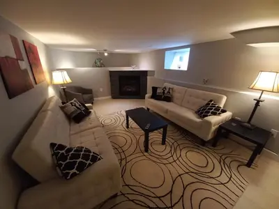 a living room with a couch and a fireplace at Niagara Falls Dream Family Retreat in Niagara Falls