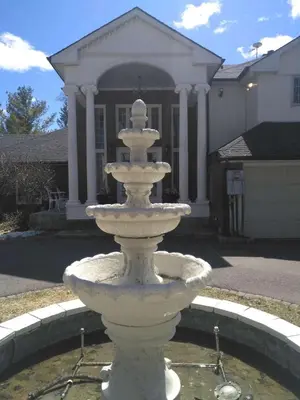 a white fountain in front of a house at Lakeside Private suite-Queen bed room in Tottenham