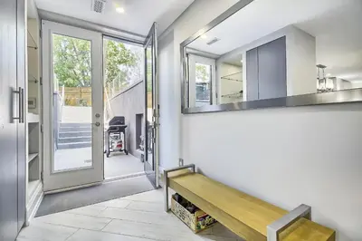 a hallway with a wooden bench in a house at Charming and Luxurious 2BR+1Bath Guest Suite in Toronto