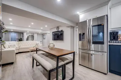 a kitchen and living room with a stainless steel refrigerator at Vacation Suite in Pickering in Pickering