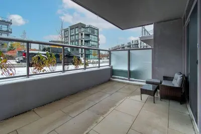 an apartment balcony with a view of a city at PET FRIENDLY CONDOS at FRIDAY HARBOUR in Innisfil