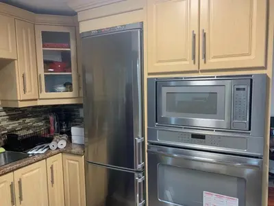 a kitchen with a stainless steel refrigerator and microwave at Guest House Room No 03 in Mississauga