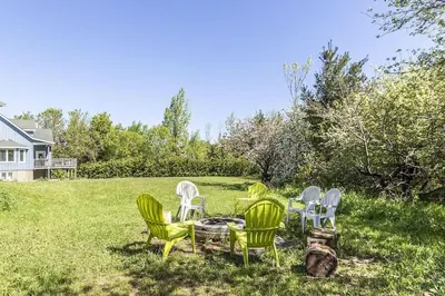 a group of chairs and a table in the grass at Panoramic-Blue Mountain-Balcony-Sauna-Backyard-King in Blue Mountains