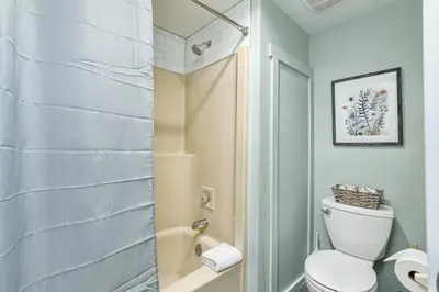 a bathroom with a white toilet and a shower at The Nordic - Central Collingwood Condo in Collingwood