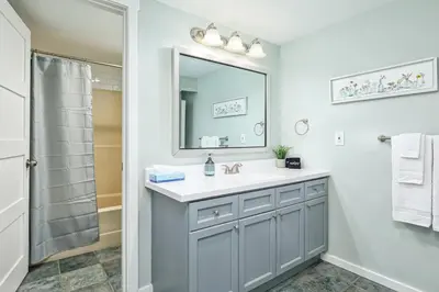 a bathroom with a sink and a mirror at The Nordic - Central Collingwood Condo in Collingwood