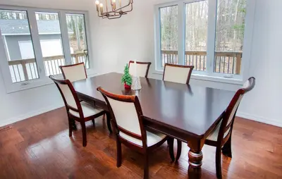 a dining room with a table and chairs at Mountain House in the Heart of Haliburton, Mins to Lake in Haliburton