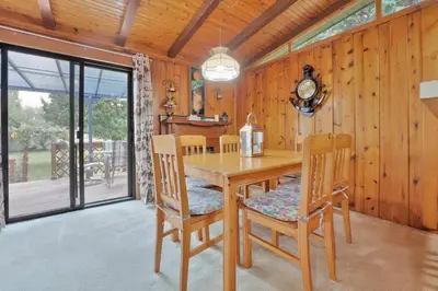 a dining room with a wooden table and chairs at Rustic cottage on Canal Lake in Carden
