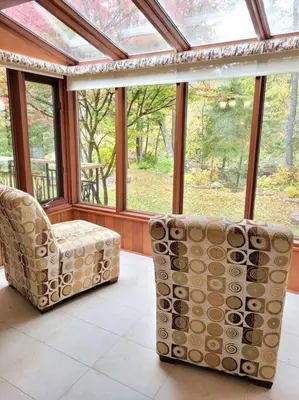 a room with two chairs in front of a window at Whispering Pines Riverside Retreat in Coboconk