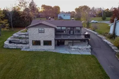 an aerial view of a house with a driveway at Chemong Lake Waterfront Cottage☆privateboatlaunch in Lakefield