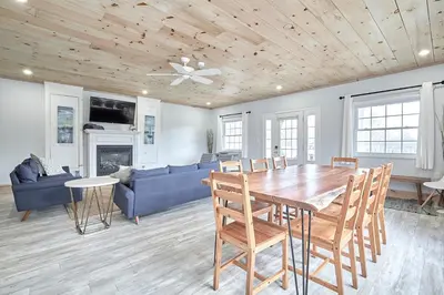 a living room with a table and a blue couch at Muskoka Honey Harbour 4-Bed Retreat with Hot Tub in Honey Harbor