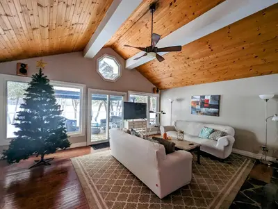 a living room with a christmas tree and a couch at Cozy Escape, Kawarthas Cottage With Sauna in Buckhorn