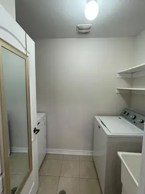 a small white kitchen with a sink and a counter at Luxury 4-Bedrooms Home… in Brampton