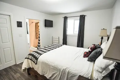 a bedroom with a bed and a window at Modern Rustic Home with Wood Stove & Pool Table in Kemble