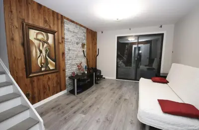 a living room with a white couch and a brick wall at La Datcha 20 Acres Private Spa, with Pool, Jacuzzi & Wood Burning Sauna in Cookstown
