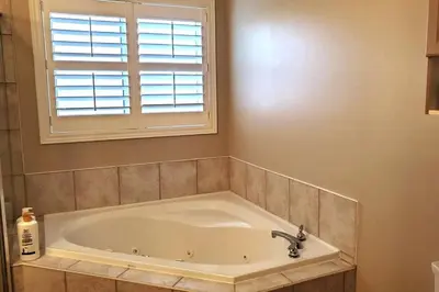 a bath tub in a bathroom with a window at Modern & Spacious 2 Bedrooms+2 Bathrooms Bungalow in Oakville in Oakville