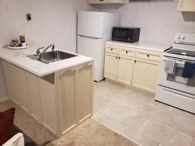 a kitchen with a sink and a white refrigerator at 2plex, Choose, 1of 2 entire units apparts in Hamilton
