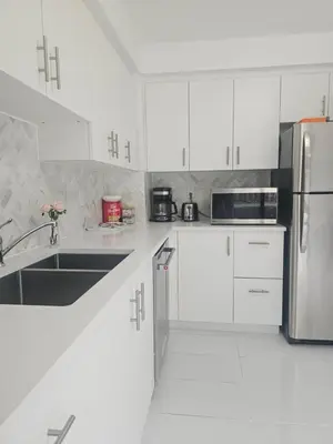 a kitchen with white cabinets and a stainless steel refrigerator at 3-Bed 3-Bath Cozy Vacation House in Ajax, Greater Toronto Area, ON, Canada in Ajax