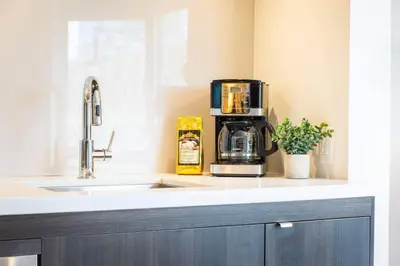 a kitchen with a coffee maker on a counter at Yorkville Living 1 BR-1BA with Gym in Upscale Area in Toronto