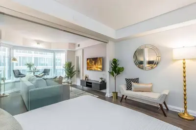 a living room with a couch and a chair at Yorkville Living 1 BR-1BA with Gym in Upscale Area in Toronto