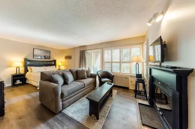 a living room with a couch and a bed at Condo 208 At North Creek Resort in Blue Mountains
