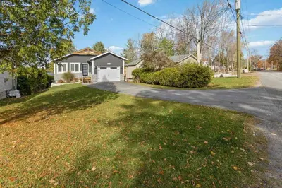 a house on a street with a driveway at Impressive Modern Waterfront Home on Georgian Bay in Port McNicoll