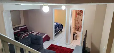 a bedroom with a bed and a chair in a room at Cozy private room in Brampton