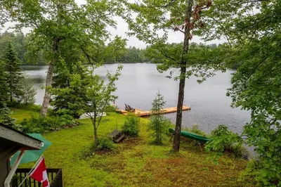 a view of a lake with a boat on it at Bear Essentials Hideaway in Huntsville