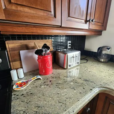 a kitchen counter with a toaster and a red can on it at The Pandora Century Home in Kitchener